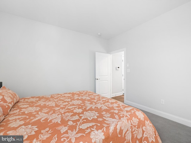 carpeted bedroom featuring baseboards