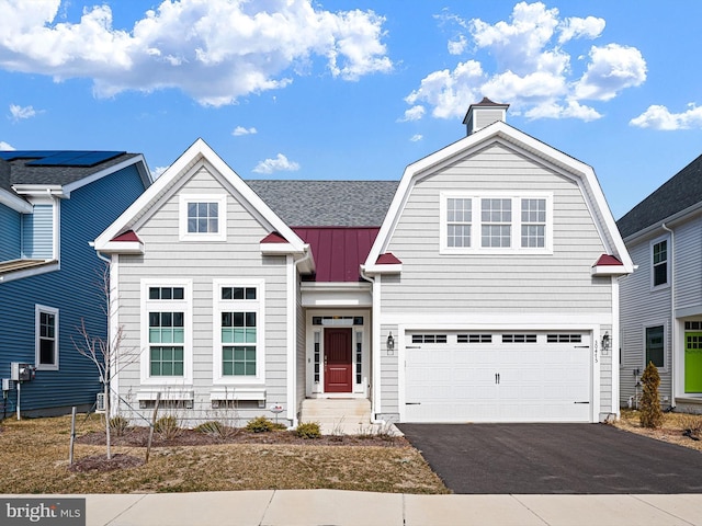 view of front of home featuring aphalt driveway, a shingled roof, a gambrel roof, a standing seam roof, and metal roof