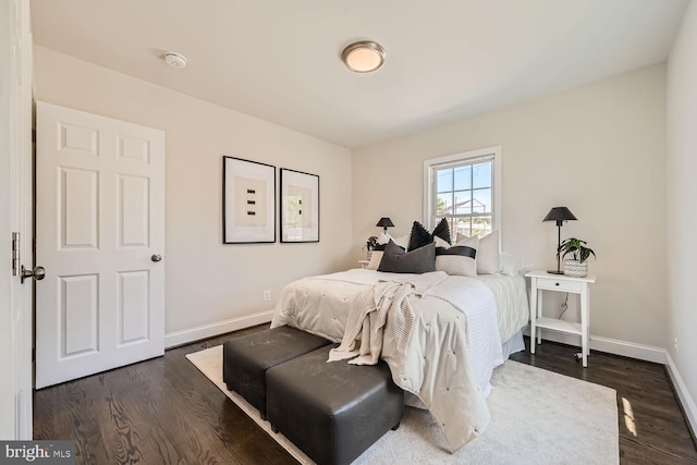 bedroom with dark hardwood / wood-style floors