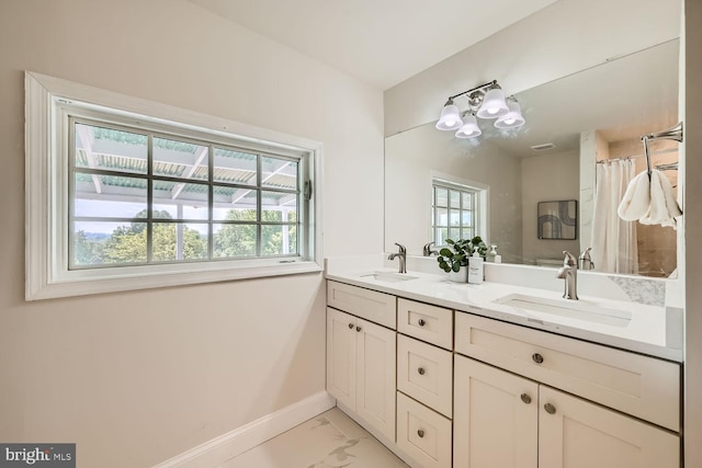 bathroom featuring a healthy amount of sunlight and vanity