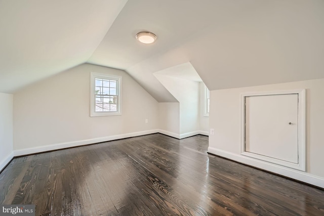 bonus room featuring lofted ceiling and dark hardwood / wood-style flooring