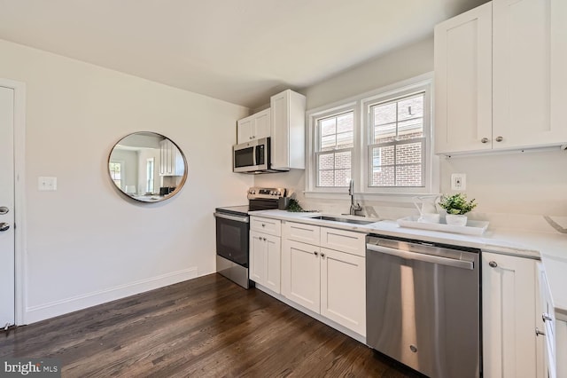 kitchen with sink, white cabinets, dark hardwood / wood-style floors, and appliances with stainless steel finishes