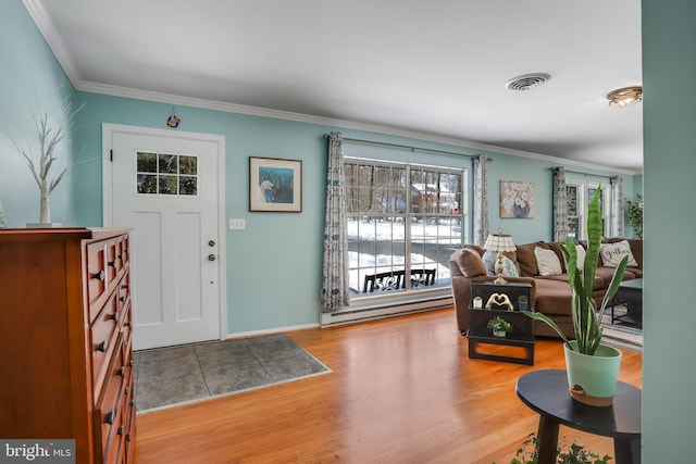 entryway featuring a baseboard radiator, hardwood / wood-style floors, and crown molding