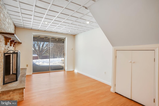 unfurnished living room with light wood-type flooring and a fireplace