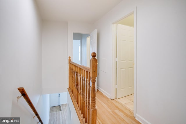 hallway with light hardwood / wood-style flooring