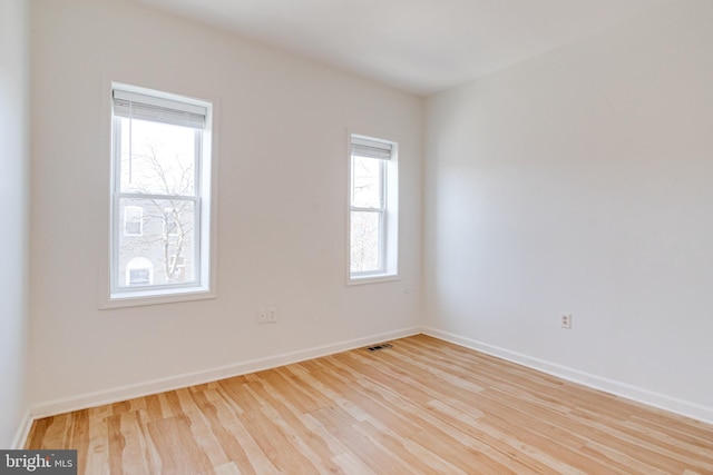 empty room with light hardwood / wood-style flooring