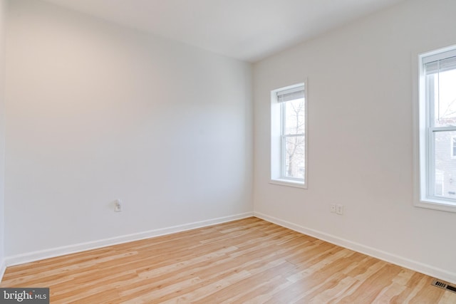 spare room with light wood-type flooring