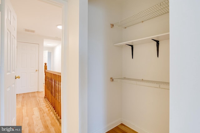 spacious closet with hardwood / wood-style floors