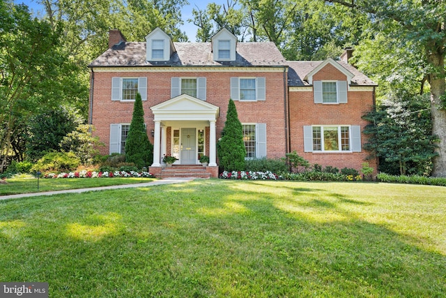 colonial home with a front lawn