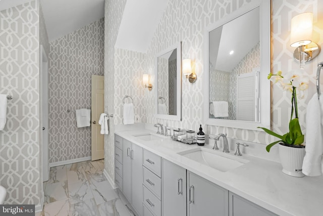 bathroom with vaulted ceiling and vanity