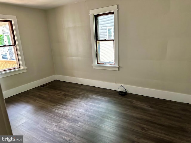 spare room featuring dark hardwood / wood-style flooring