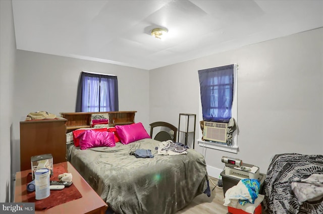 bedroom featuring light wood-type flooring and cooling unit