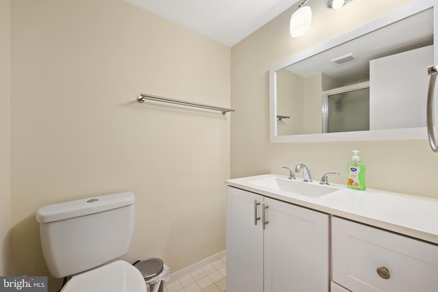 bathroom with walk in shower, vanity, and toilet