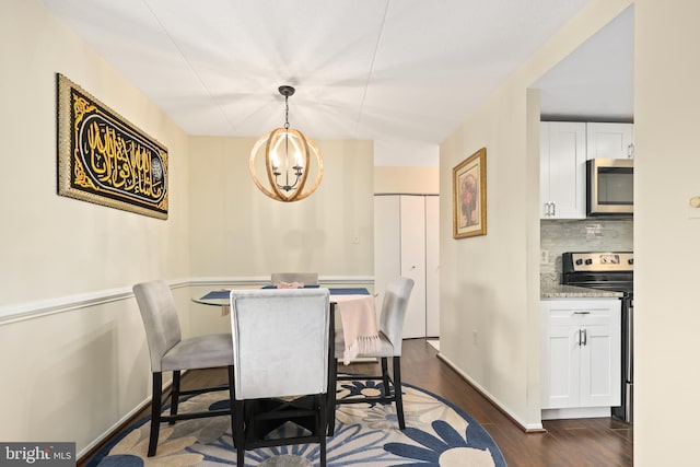 dining area featuring dark hardwood / wood-style floors and a notable chandelier