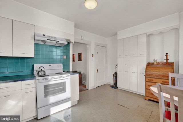 kitchen with under cabinet range hood, white cabinets, electric range, and decorative backsplash