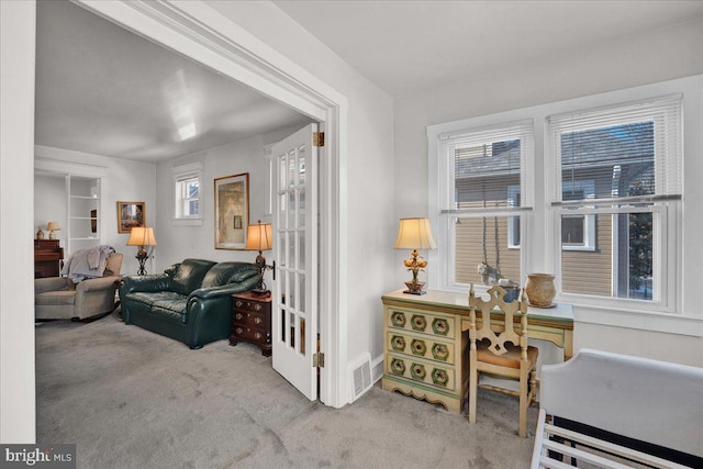 sitting room featuring carpet flooring and visible vents