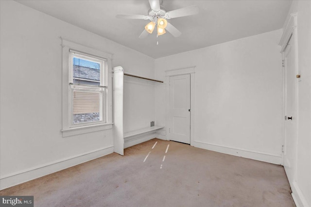 spare room featuring a ceiling fan and baseboards