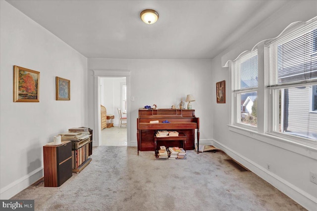 misc room featuring carpet floors, visible vents, and baseboards