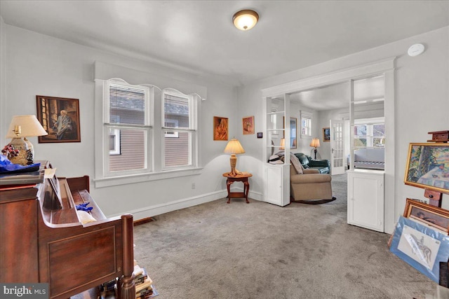 interior space with carpet flooring and baseboards