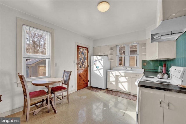 kitchen featuring white cabinets, decorative backsplash, sink, and white appliances