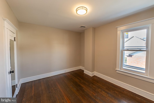 unfurnished room with dark hardwood / wood-style floors