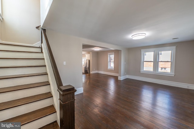 unfurnished living room with dark hardwood / wood-style flooring