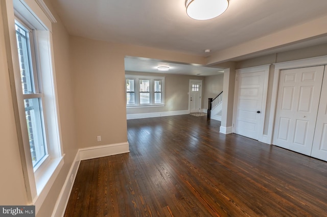 spare room with dark wood-type flooring