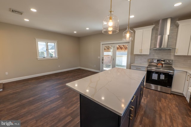 kitchen featuring white cabinetry, a center island, dark hardwood / wood-style floors, wall chimney range hood, and electric range