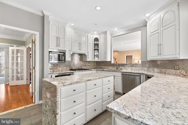 kitchen with white cabinetry, ornamental molding, and appliances with stainless steel finishes
