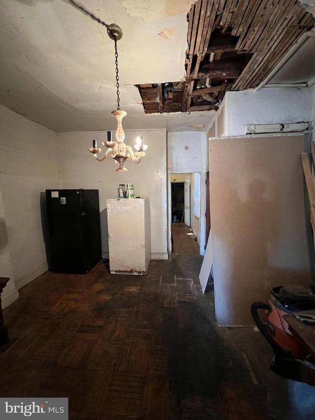 unfurnished dining area featuring dark parquet flooring and an inviting chandelier