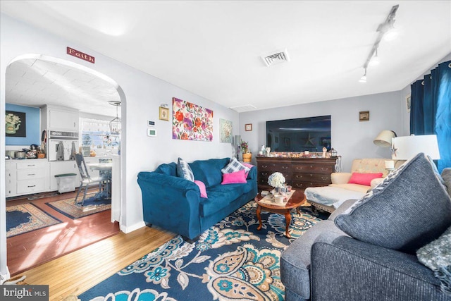 living room featuring track lighting and hardwood / wood-style floors