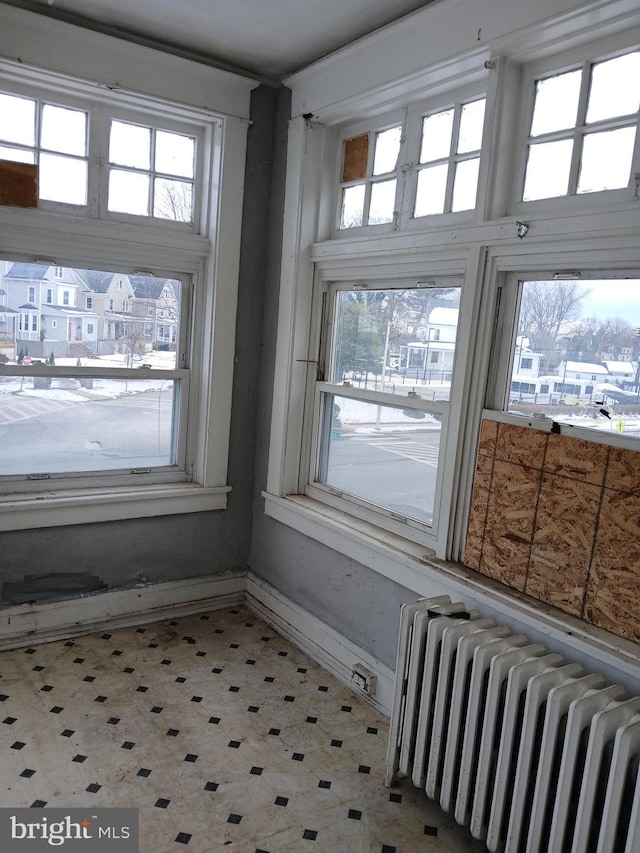 sunroom / solarium featuring radiator