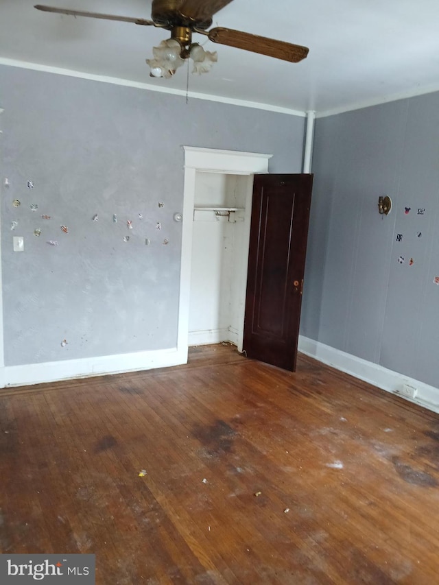 unfurnished bedroom featuring wood-type flooring, a closet, and ceiling fan