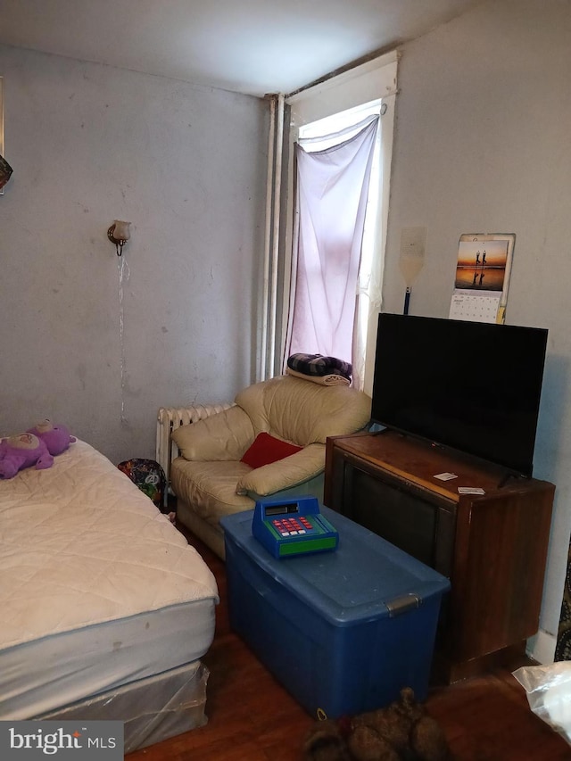 bedroom with dark wood-type flooring