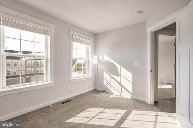 spare room featuring light colored carpet