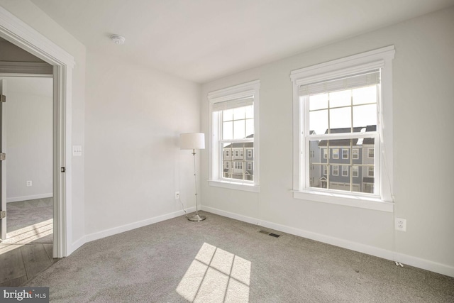 unfurnished room featuring light colored carpet