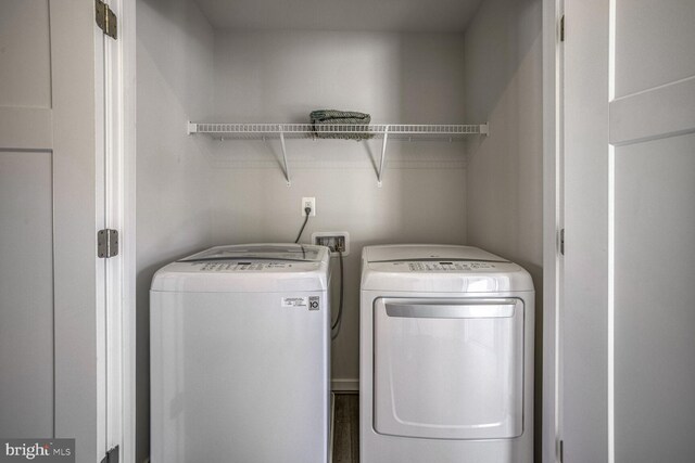 clothes washing area featuring washer and clothes dryer