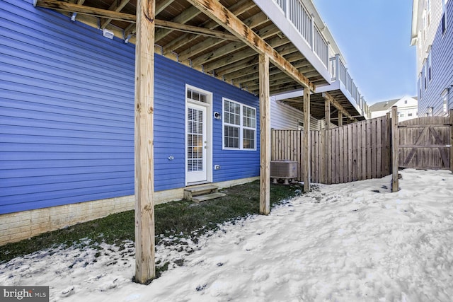 snow covered property featuring central air condition unit