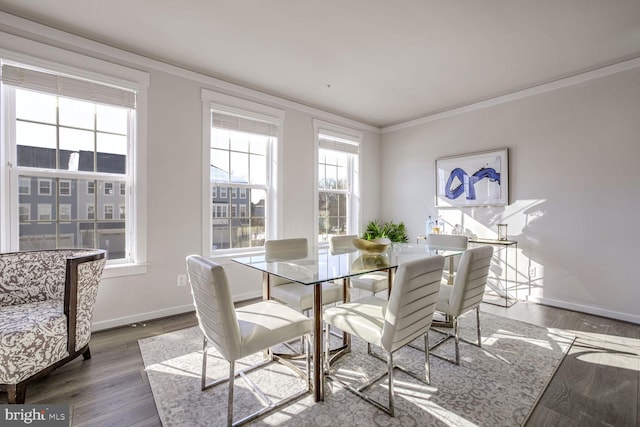 dining area featuring hardwood / wood-style floors and crown molding