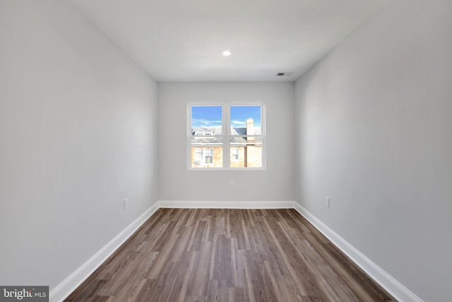 empty room with dark wood-type flooring