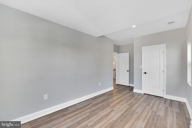 spare room featuring light hardwood / wood-style floors