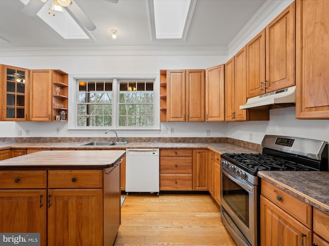 kitchen featuring ceiling fan, gas range, white dishwasher, crown molding, and sink