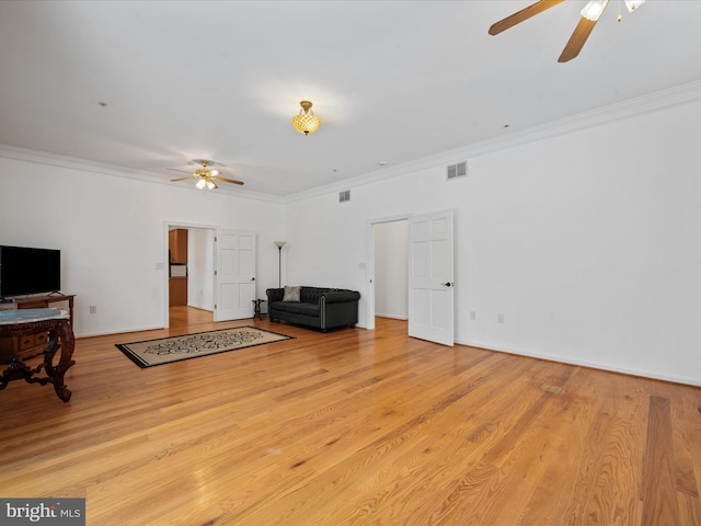 living room featuring light wood-type flooring and crown molding