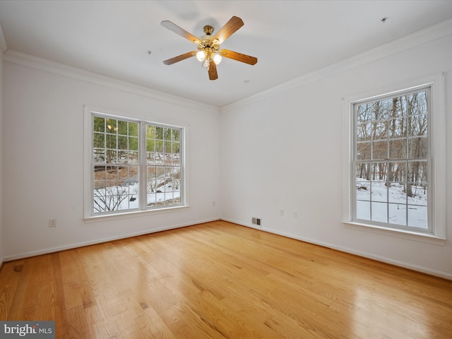 unfurnished room with light hardwood / wood-style floors, ornamental molding, and ceiling fan