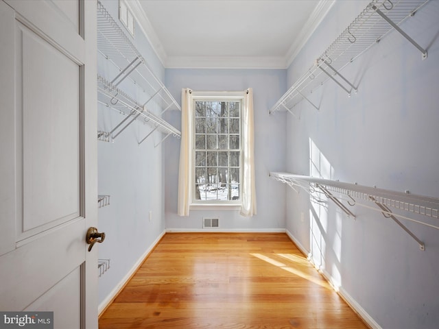 spacious closet featuring light hardwood / wood-style floors