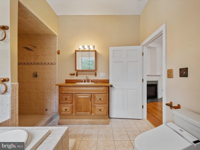 full bathroom featuring toilet, vanity, tile patterned flooring, and plus walk in shower