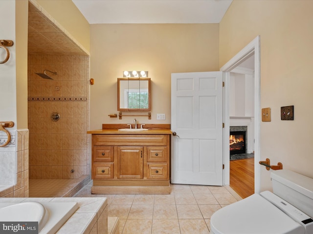 full bathroom featuring toilet, tile patterned floors, separate shower and tub, and vanity