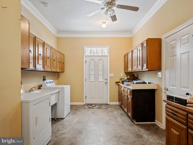 clothes washing area featuring cabinets, separate washer and dryer, crown molding, and ceiling fan