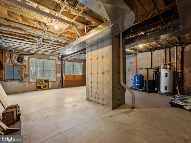 basement featuring water heater and electric panel