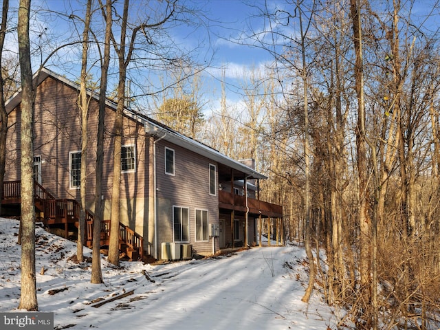 snow covered property featuring a balcony